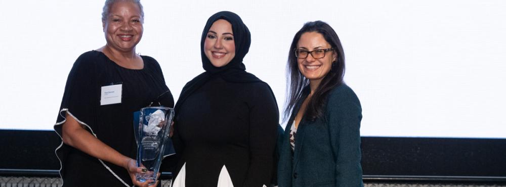 Pam Duncan (DES Deputy Director and Chief Transformation Officer), Huda Al-musawi (NWMMSDC Manager of Operations), and Kate Kleyman (NWMMSDC Board Vice Chairperson and Senior Program Manager at McKinstry) pose for a picture with the award for DES. 