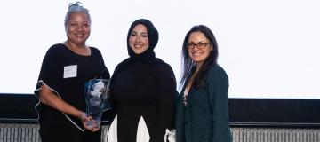 Pam Duncan (DES Deputy Director and Chief Transformation Officer), Huda Al-musawi (NWMMSDC Manager of Operations), and Kate Kleyman (NWMMSDC Board Vice Chairperson and Senior Program Manager at McKinstry) pose for a picture with the award for DES. 